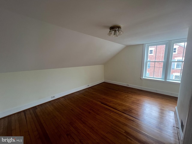 additional living space featuring lofted ceiling and wood-type flooring