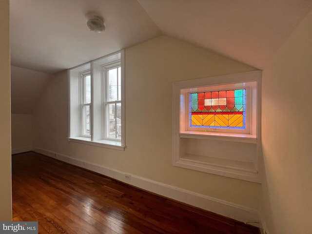 bonus room featuring dark hardwood / wood-style floors and vaulted ceiling