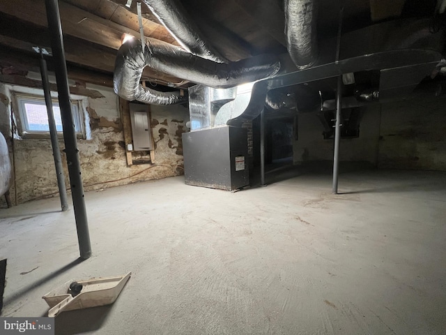 basement with electric panel and heating unit