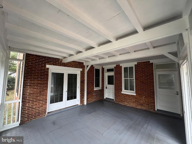 unfurnished sunroom featuring french doors and beamed ceiling