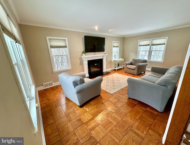 living room with ornamental molding and light parquet flooring