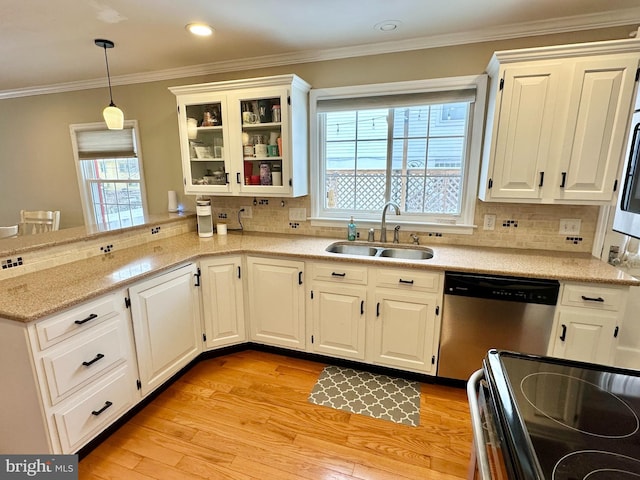 kitchen featuring sink, hanging light fixtures, stainless steel dishwasher, tasteful backsplash, and white cabinetry