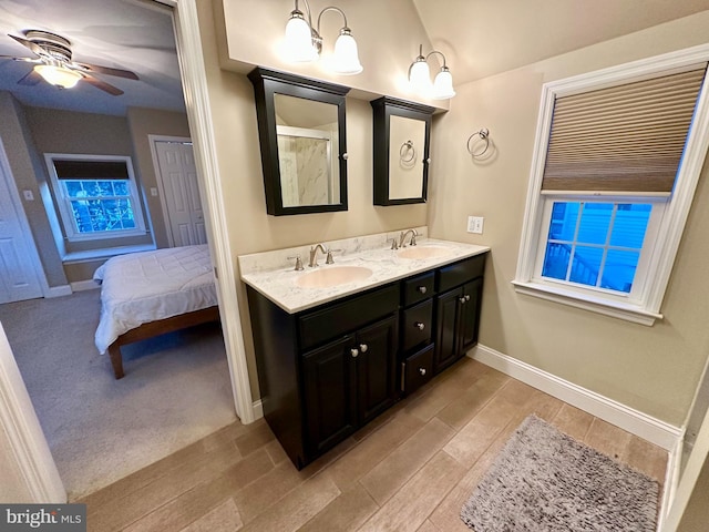 bathroom with vanity, hardwood / wood-style floors, and ceiling fan