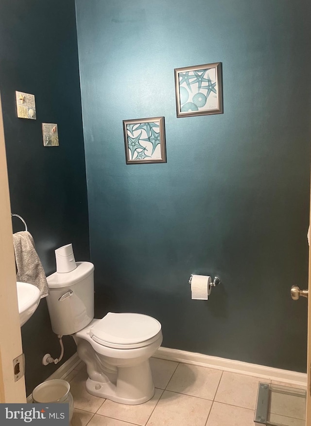 bathroom with tile patterned flooring and toilet