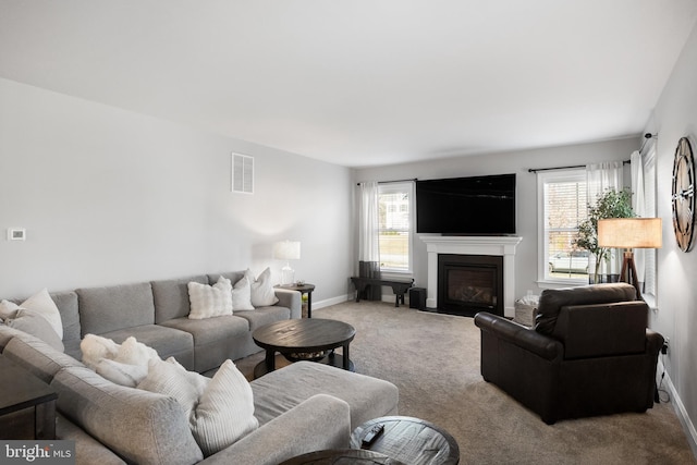 living room featuring light colored carpet and a healthy amount of sunlight