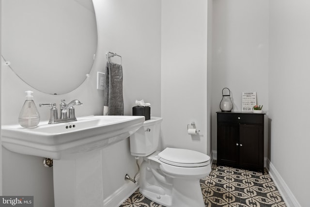 bathroom with tile patterned flooring, toilet, and sink