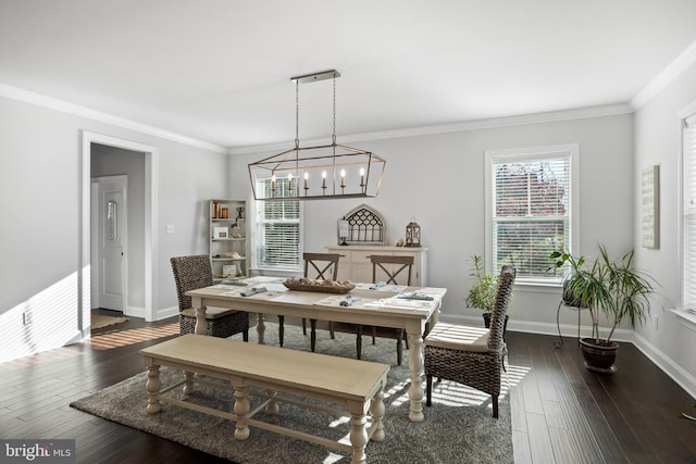 dining space with dark hardwood / wood-style floors, ornamental molding, and a chandelier