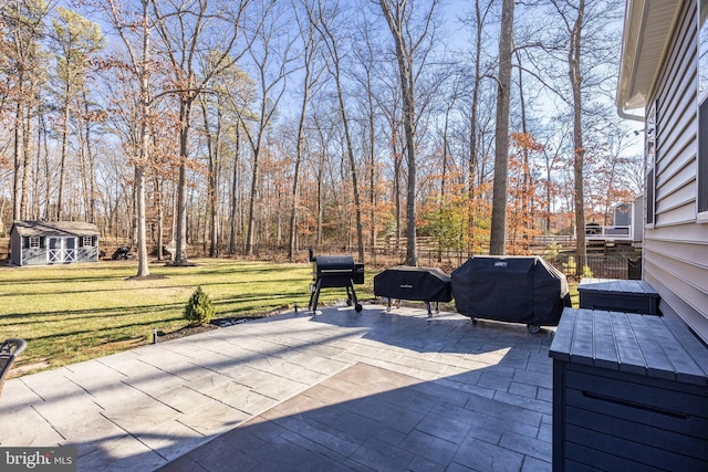 view of patio / terrace with an outdoor structure and a grill