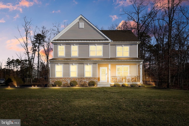 front facade featuring a yard and a porch