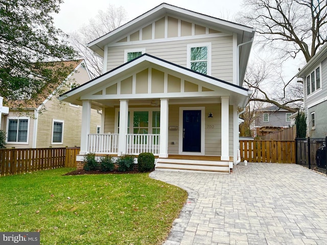 view of front of home with covered porch and a front yard