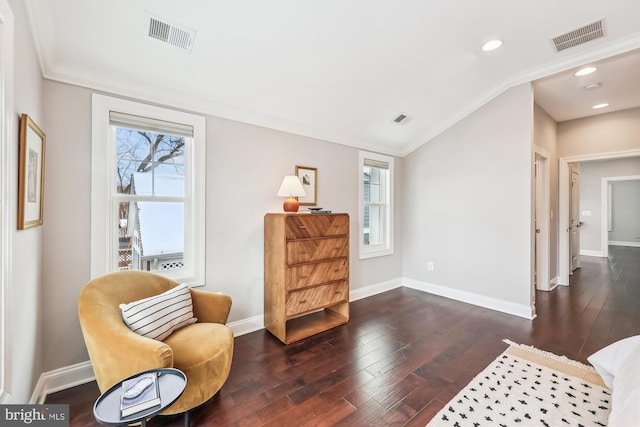 living area with dark hardwood / wood-style flooring and crown molding