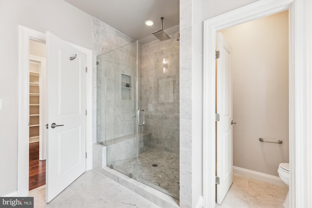 bathroom with toilet and walk in shower