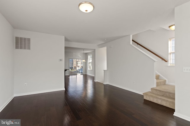 unfurnished living room with dark hardwood / wood-style flooring