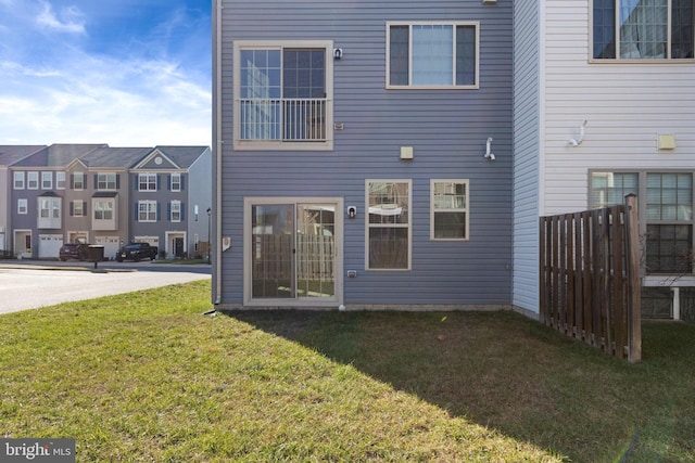 rear view of property with a yard