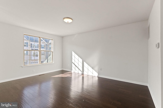 unfurnished room featuring dark hardwood / wood-style flooring