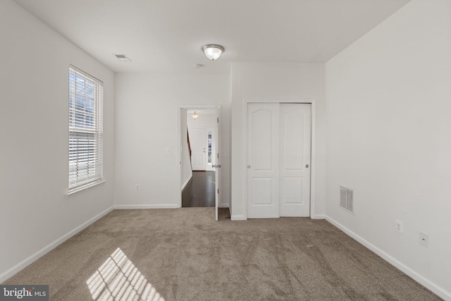 unfurnished bedroom with carpet floors and a closet