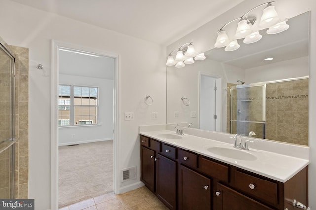 bathroom with tile patterned flooring, vanity, and an enclosed shower