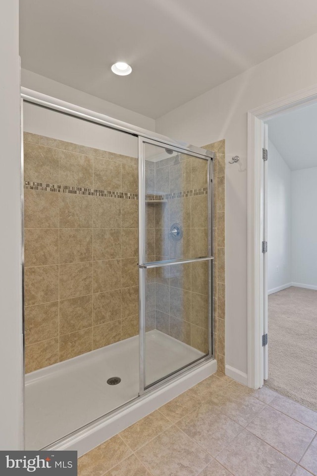 bathroom with tile patterned floors and a shower with shower door