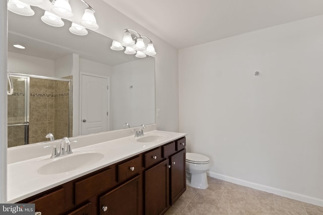 bathroom with vanity, toilet, and an enclosed shower