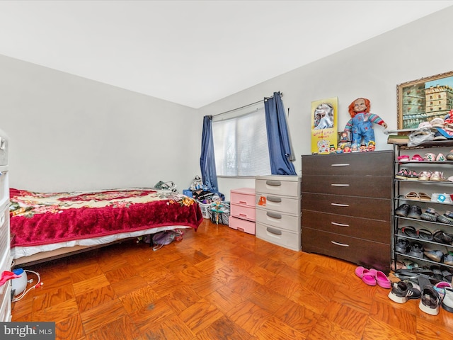 bedroom with light parquet flooring