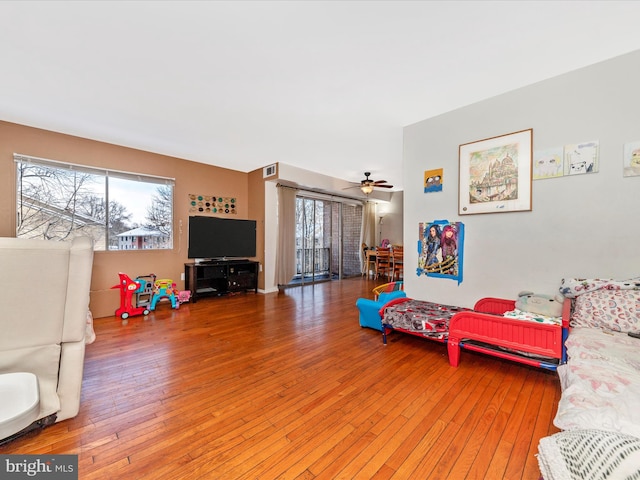 living room featuring ceiling fan and wood-type flooring