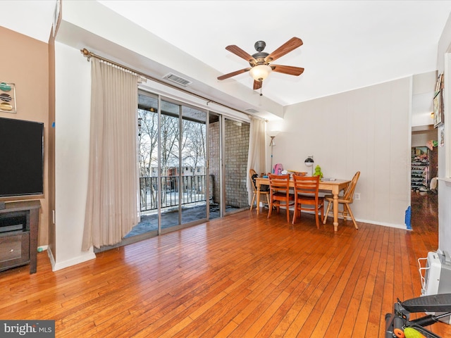 dining area with ceiling fan and hardwood / wood-style floors