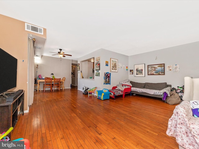 living room featuring ceiling fan and wood-type flooring