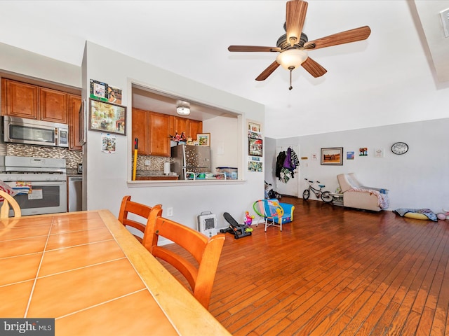 dining room featuring ceiling fan and dark wood-type flooring