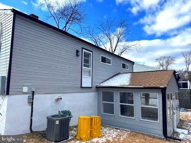rear view of house with cooling unit