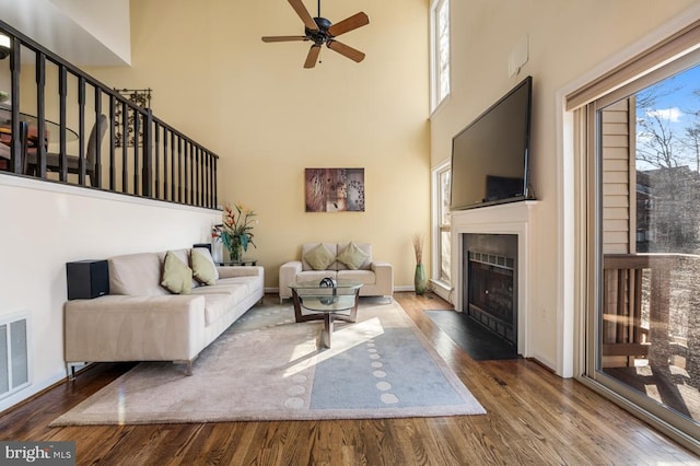 living room featuring plenty of natural light, a ceiling fan, and wood finished floors