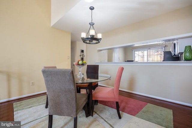 dining room featuring baseboards and an inviting chandelier