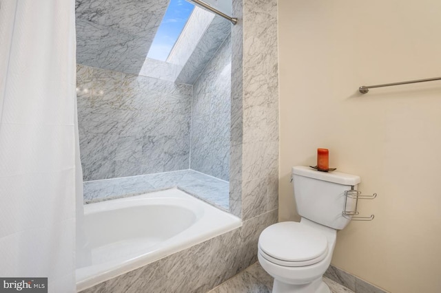 full bathroom featuring shower / tub combo and toilet