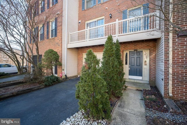 property entrance featuring brick siding