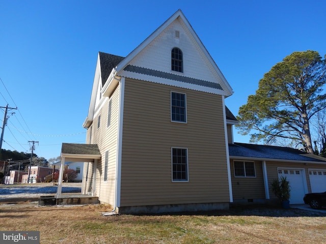 view of home's exterior with a yard and a garage