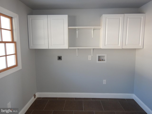 laundry area with hookup for an electric dryer, cabinets, a wealth of natural light, and washer hookup