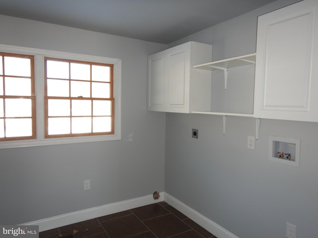 laundry area featuring cabinets, washer hookup, dark tile patterned floors, and electric dryer hookup