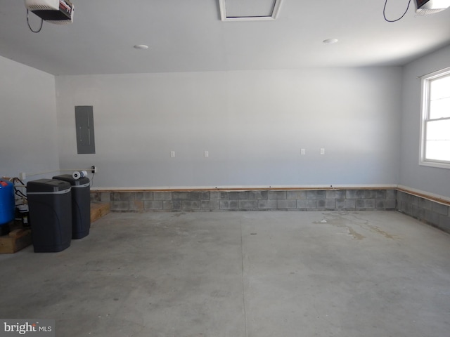 garage featuring electric panel and a garage door opener