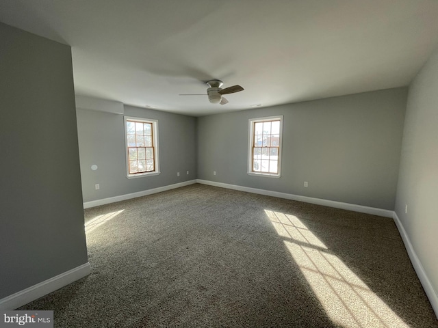 empty room featuring carpet flooring and ceiling fan