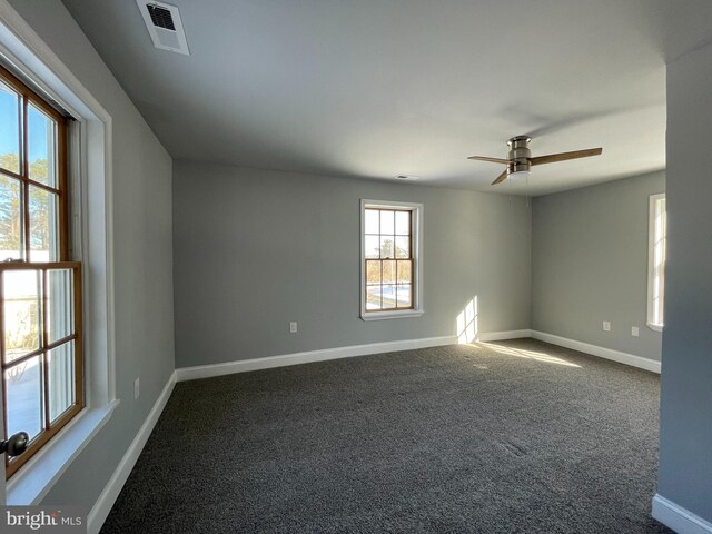 spare room featuring carpet and ceiling fan