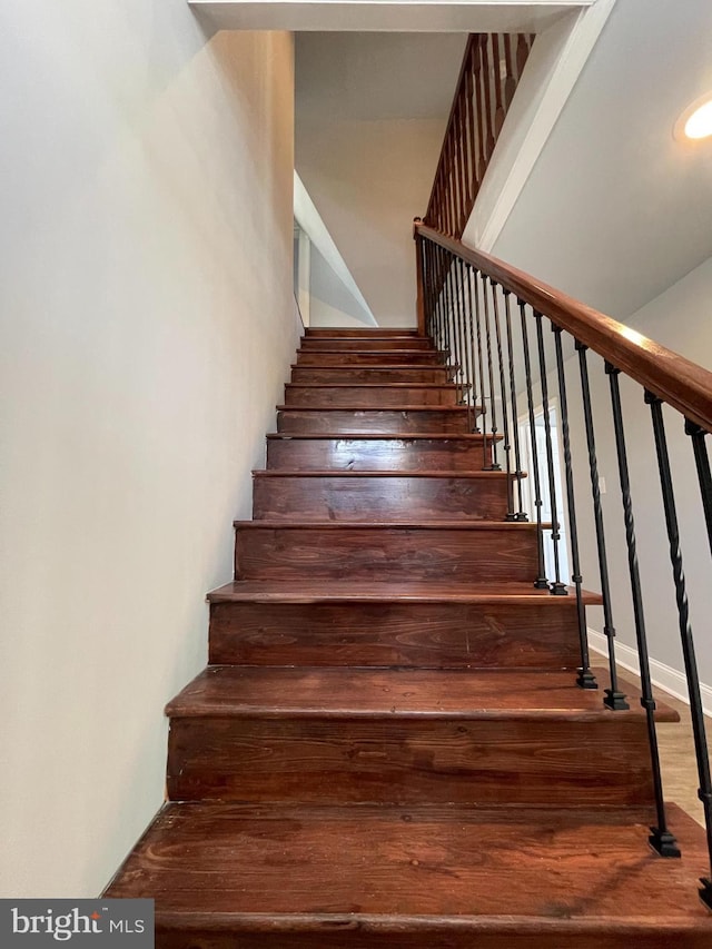 staircase featuring hardwood / wood-style floors