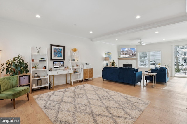 living room with ceiling fan, crown molding, light hardwood / wood-style flooring, and beamed ceiling