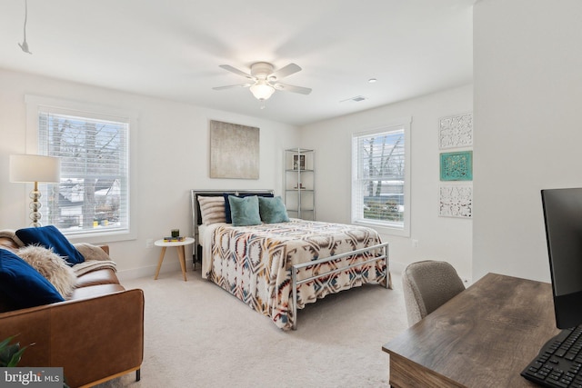 bedroom featuring ceiling fan, carpet, and multiple windows