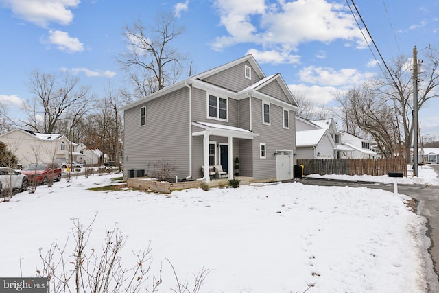 snow covered property featuring cooling unit