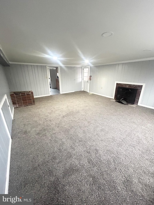 unfurnished living room with carpet floors and a brick fireplace