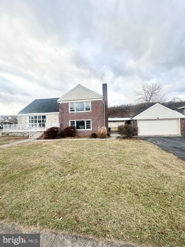 view of front of home with a front lawn and a garage