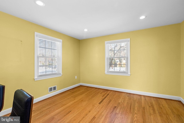 spare room with light hardwood / wood-style flooring