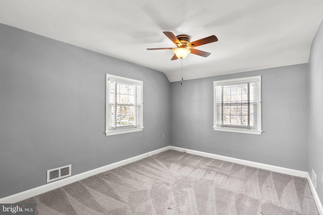 unfurnished room with ceiling fan, carpet, a wealth of natural light, and lofted ceiling