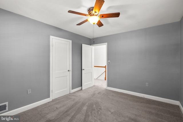 unfurnished bedroom with ceiling fan and carpet flooring