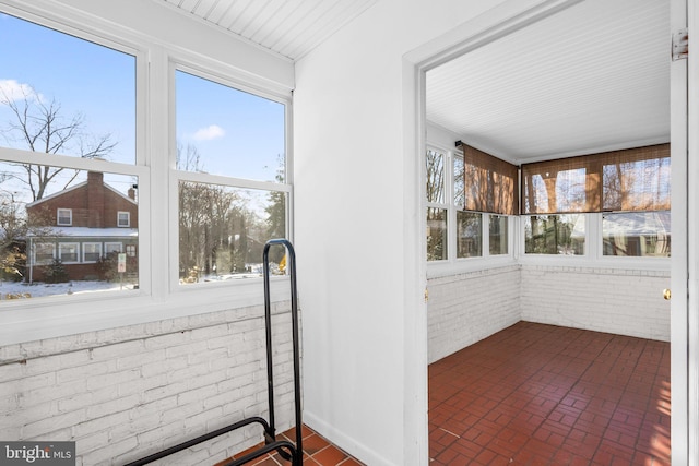 unfurnished sunroom featuring plenty of natural light