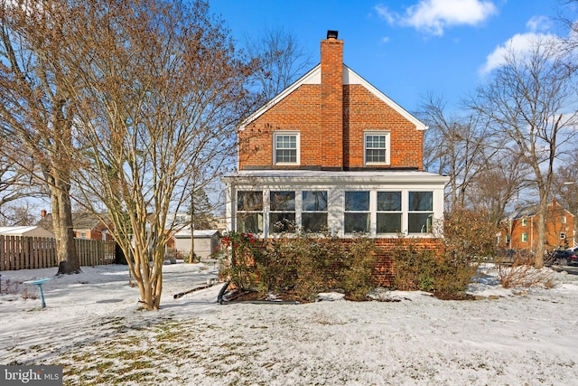 view of snow covered back of property